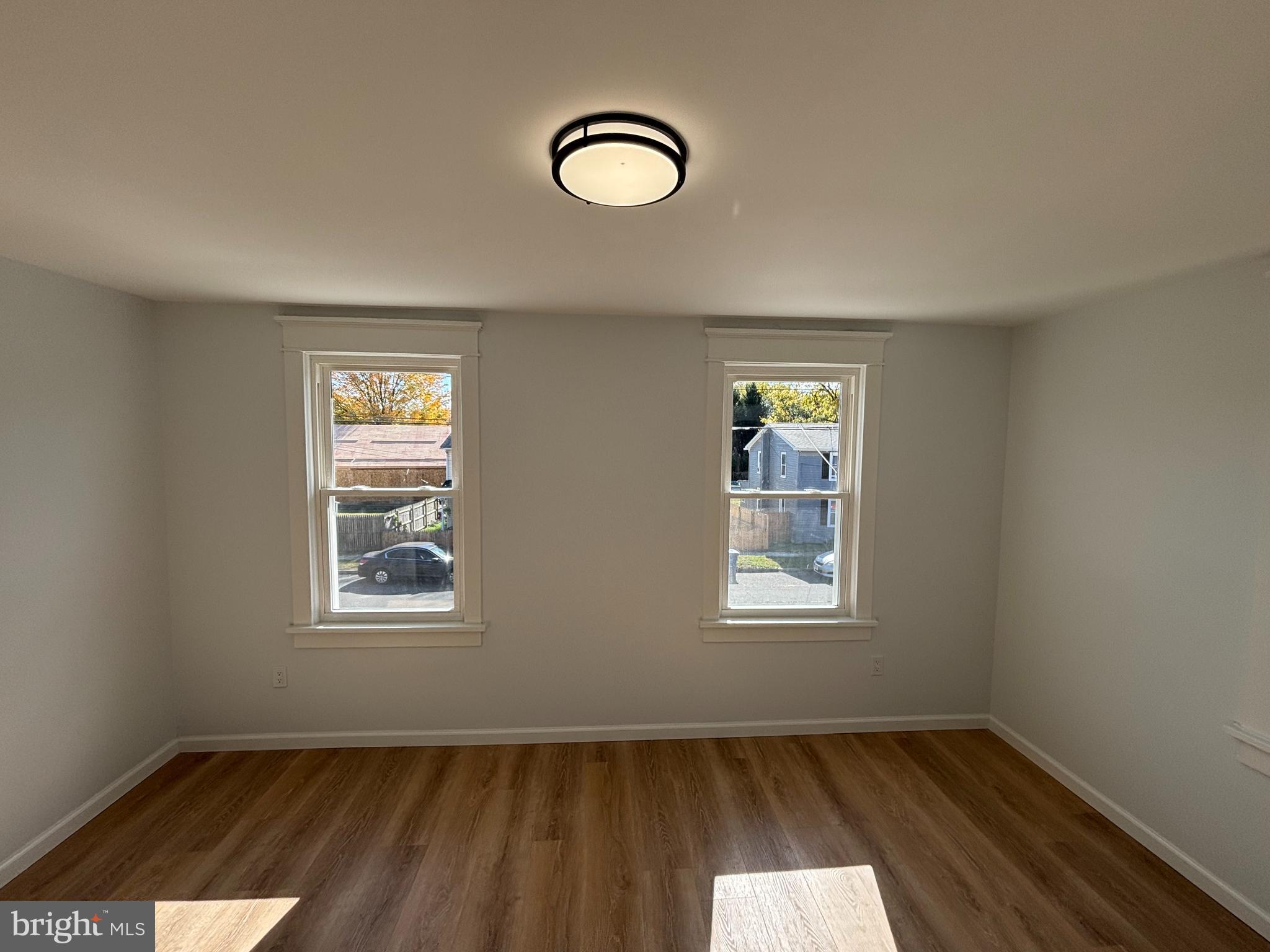 59 Pine Street Beverly, NJ 08010 - Photo 16 of 25 an empty room with wooden floor and windows