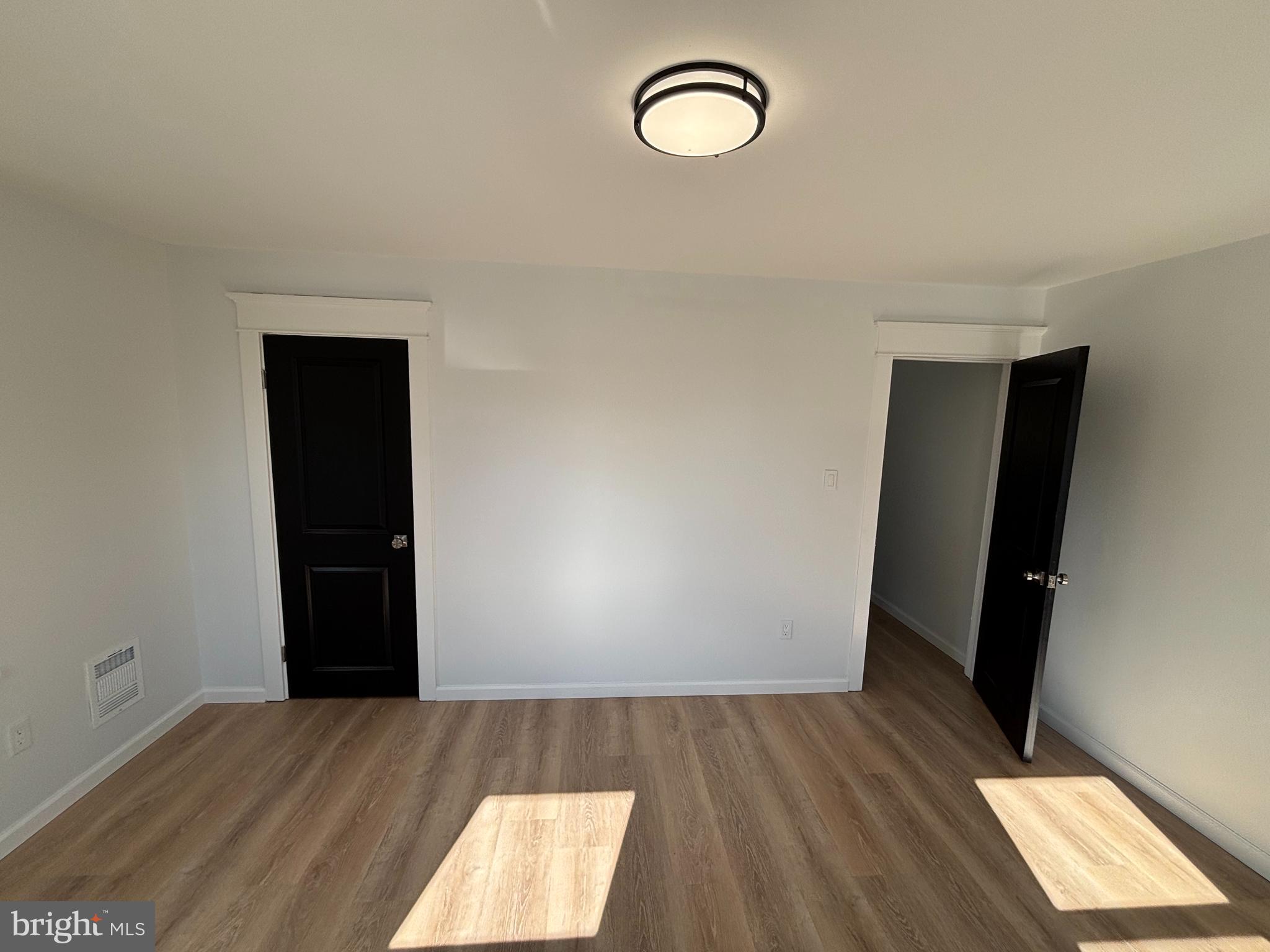 59 Pine Street Beverly, NJ 08010 - Photo 18 of 25 an empty room with wooden floor and windows
