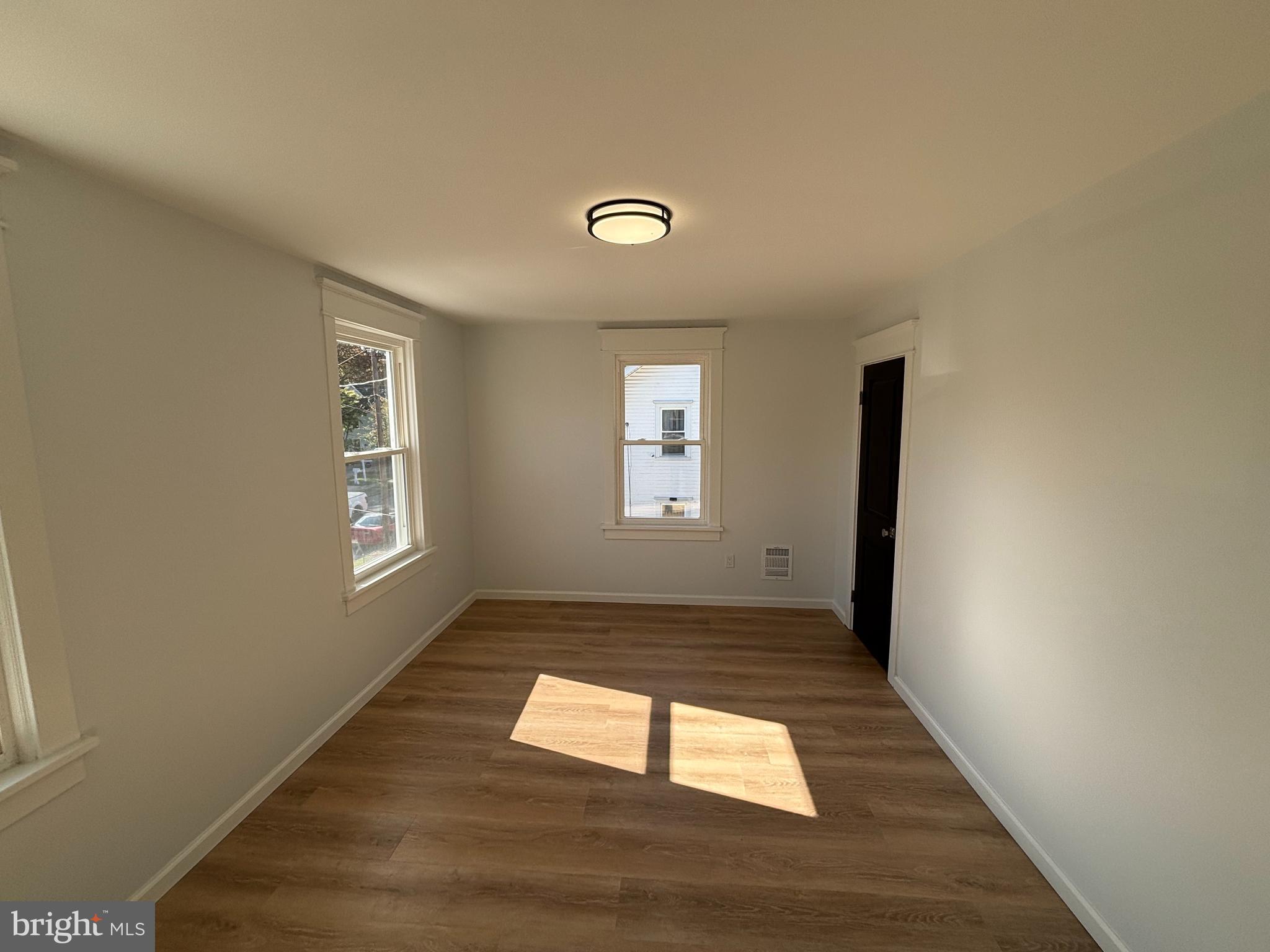 59 Pine Street Beverly, NJ 08010 - Photo 19 of 25 a view of empty room with wooden floor and fan