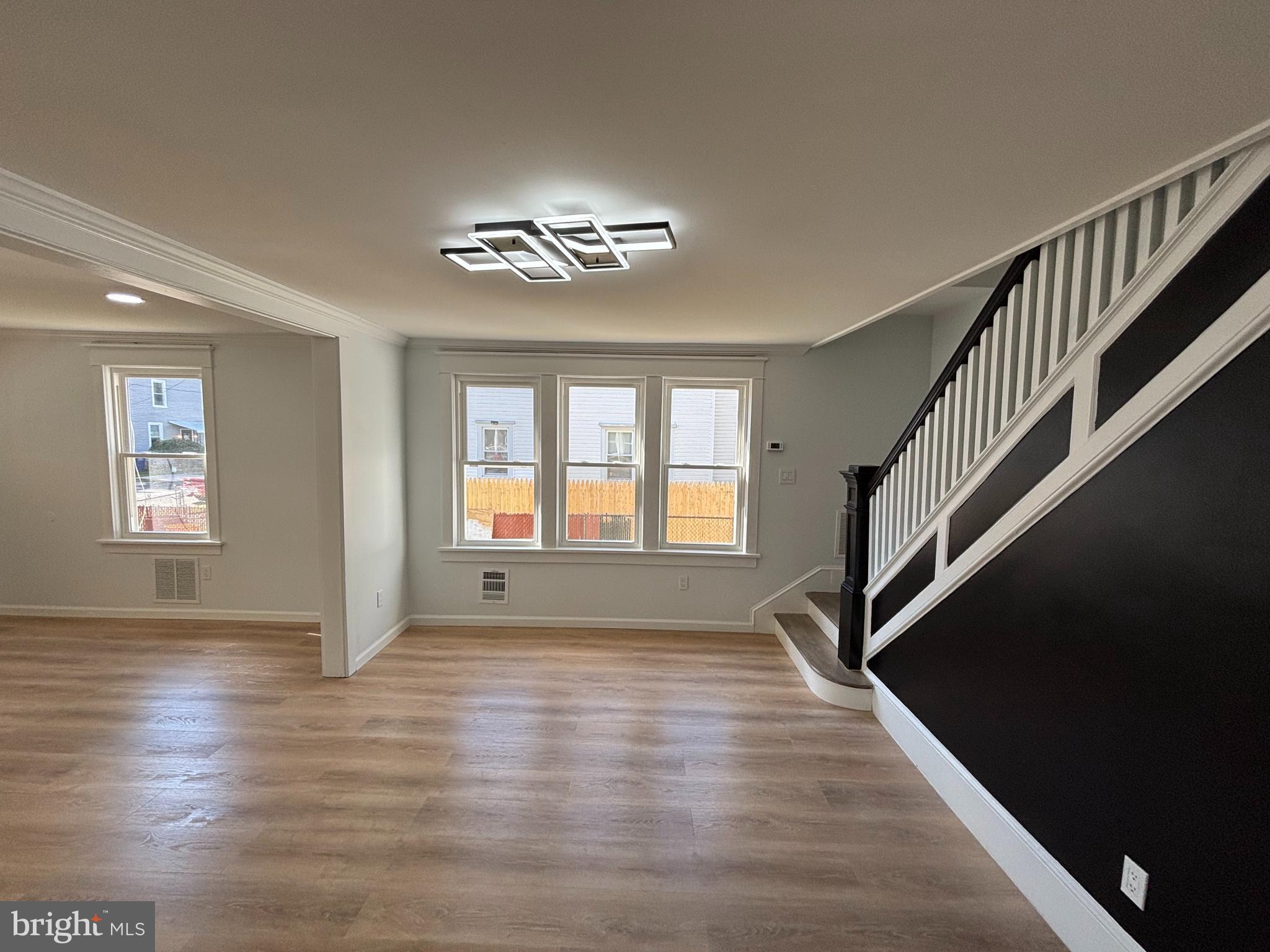 59 Pine Street Beverly, NJ 08010 - Photo 6 of 25 a view of an empty room with wooden floor and a window