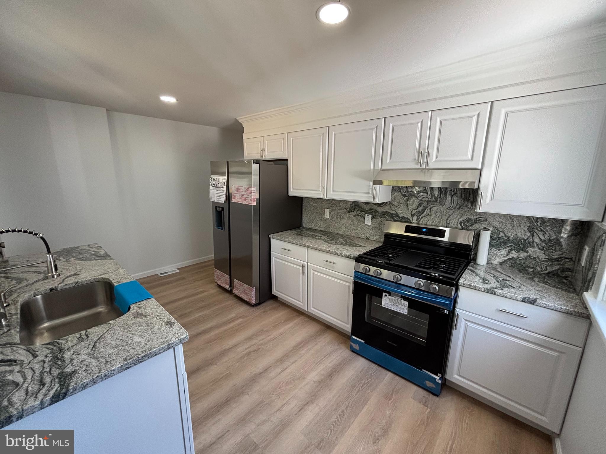 59 Pine Street Beverly, NJ 08010 - Photo 8 of 25 a kitchen that has a sink and a stove in it