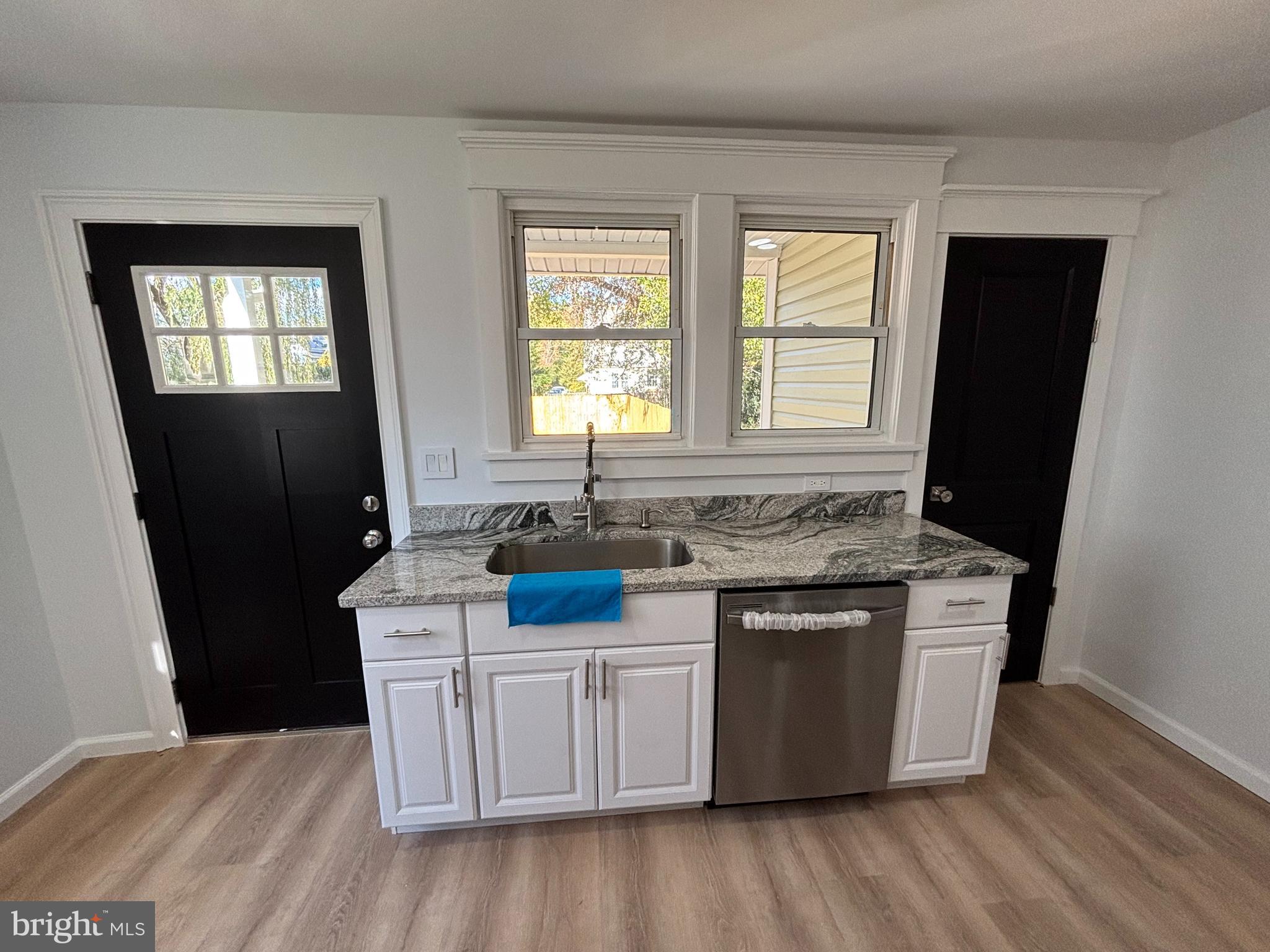 59 Pine Street Beverly, NJ 08010 - Photo 10 of 25 a kitchen with stainless steel appliances granite countertop a stove a sink a refrigerator a window and wooden floor