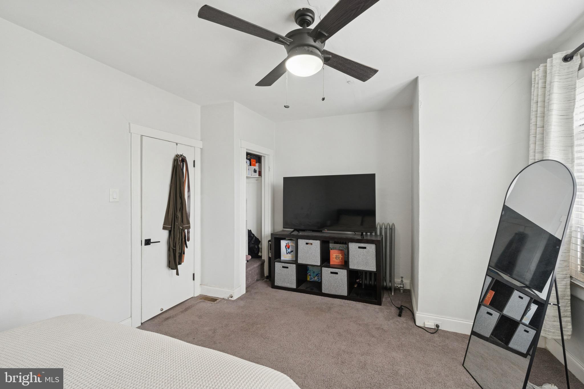 6532 Hegerman Street Philadelphia, PA 19135 - Photo 13 of 25 a living room with furniture and a flat screen tv