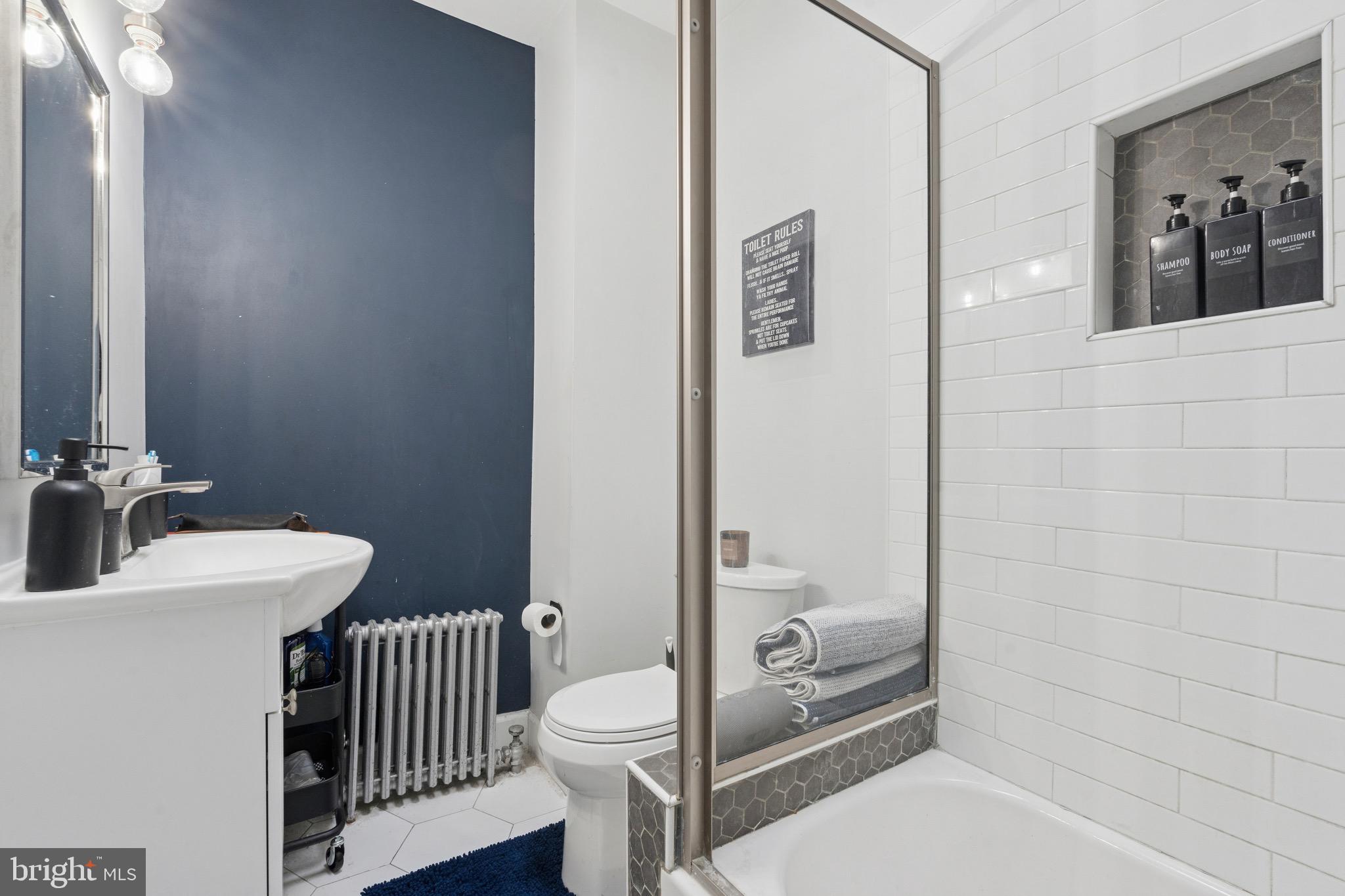 6532 Hegerman Street Philadelphia, PA 19135 - Photo 14 of 25 a bathroom with a sink a toilet and shower
