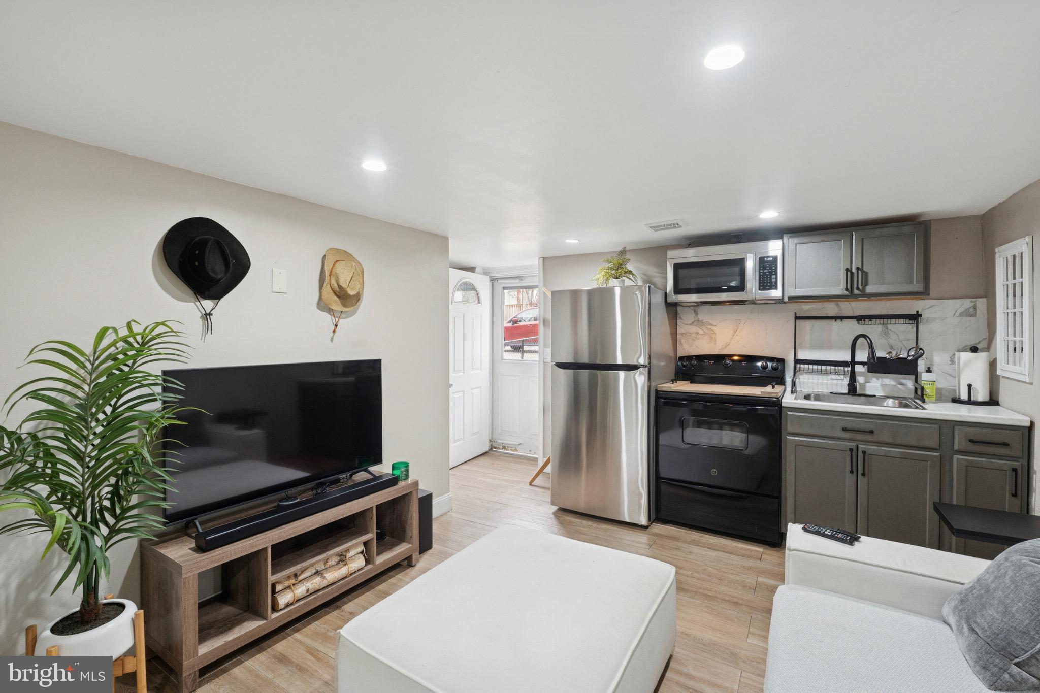 6532 Hegerman Street Philadelphia, PA 19135 - Photo 21 of 25 a kitchen with a refrigerator and a stove top oven
