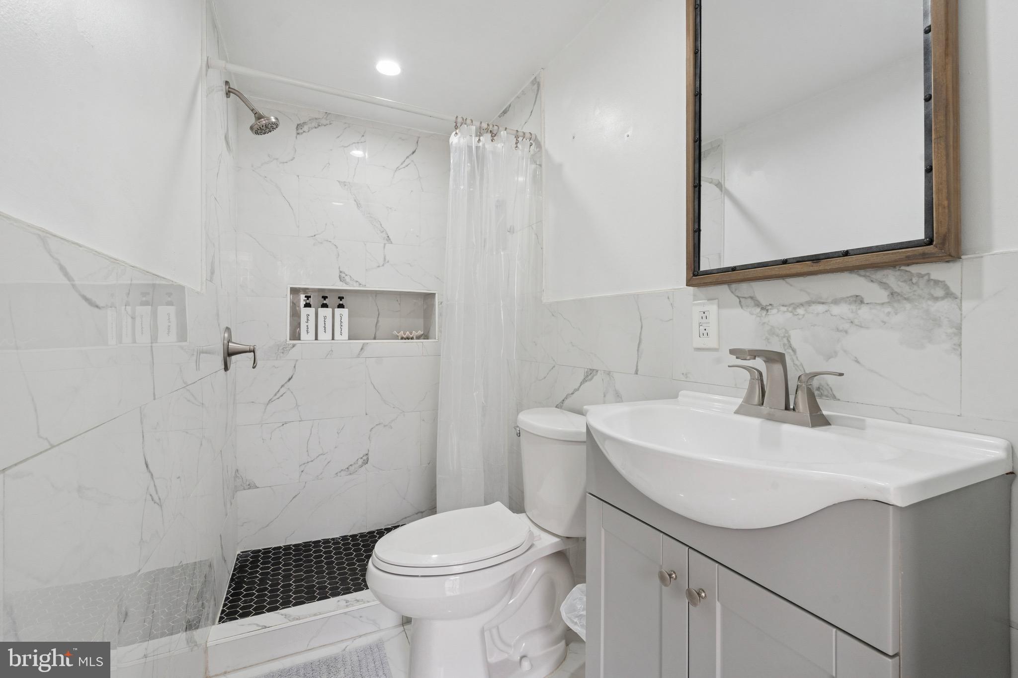 6532 Hegerman Street Philadelphia, PA 19135 - Photo 24 of 25 a bathroom with a sink toilet and shower