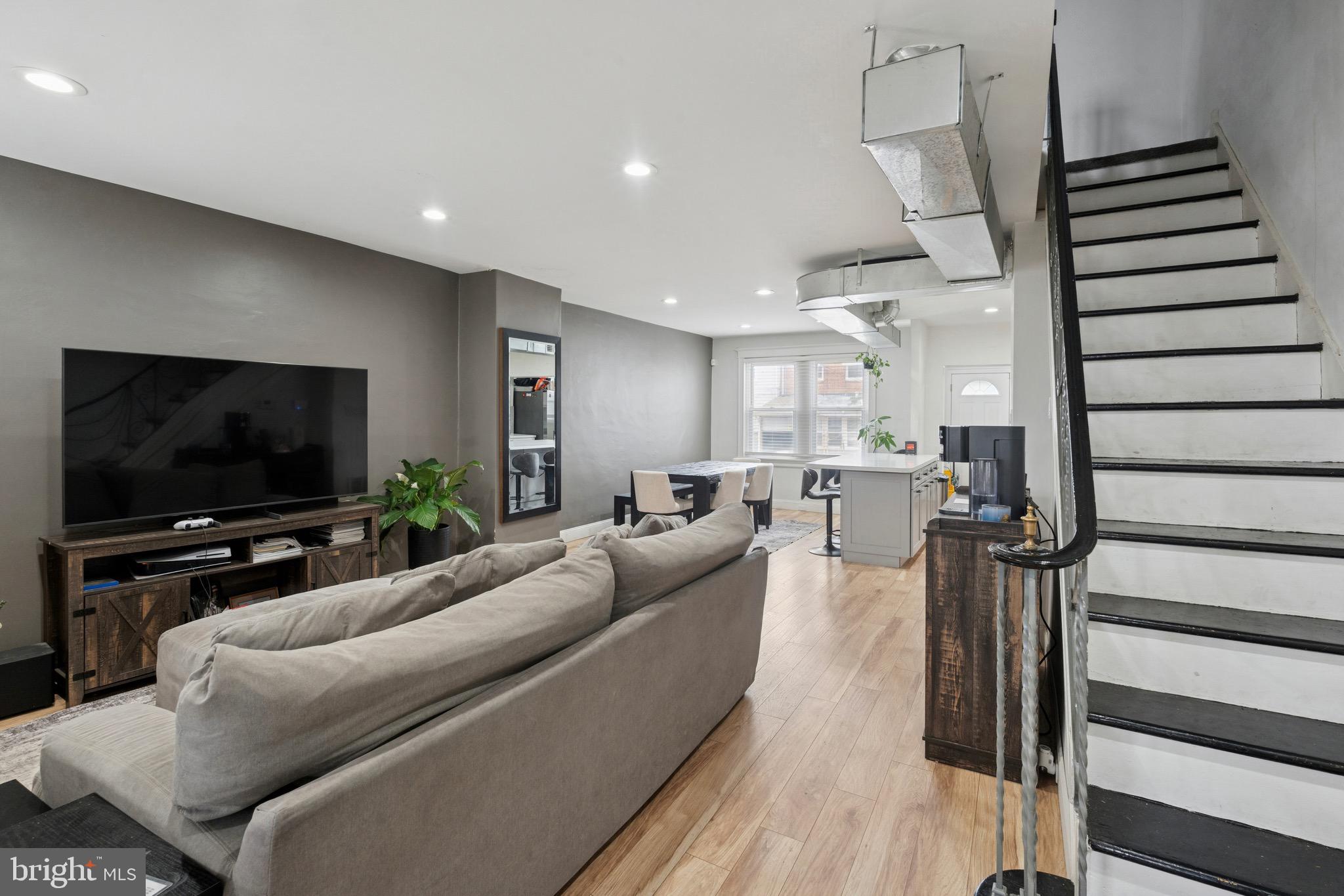 6532 Hegerman Street Philadelphia, PA 19135 - Photo 4 of 25 a living room with furniture and a flat screen tv
