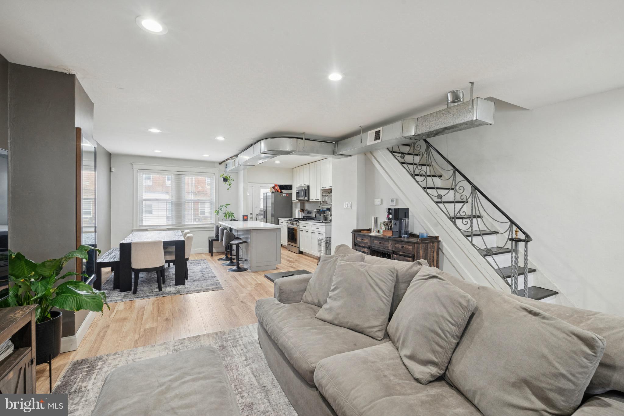 6532 Hegerman Street Philadelphia, PA 19135 - Photo 5 of 25 a living room with furniture kitchen view and a potted plant