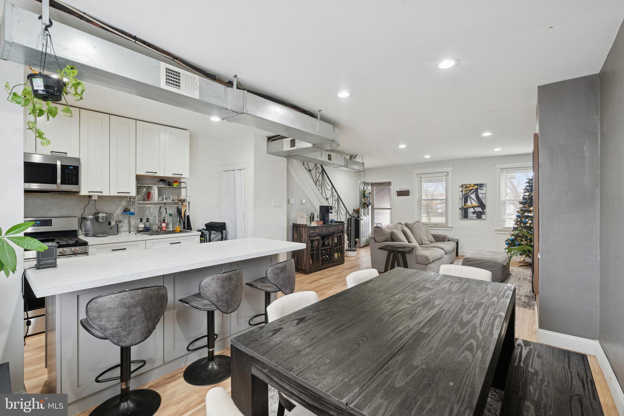 6532 Hegerman Street Philadelphia, PA 19135 - Photo 8 of 25 a large kitchen with sink a counter and chairs
