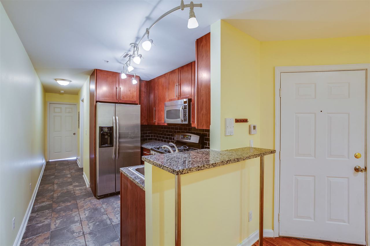 80 Madison Street, Unit 4 Hoboken, NJ 07030 - Photo 2 of 19 a bathroom with a granite countertop sink and a mirror