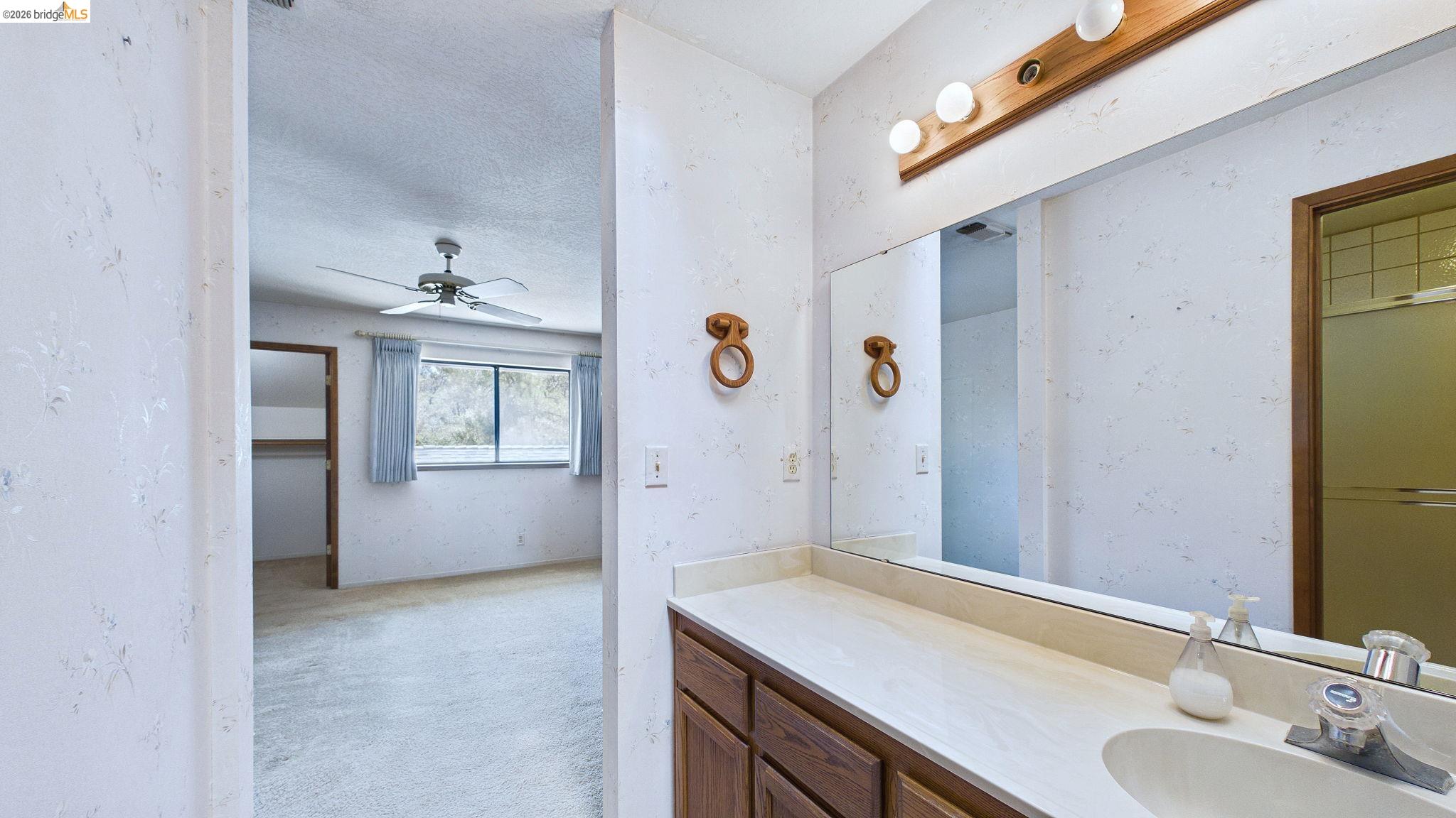 23686 Marble Quarry Road, Unit 72 Columbia, CA 95310 - Photo 25 of 35 Bathroom vanity with a single sink, built-in cabinetry, and overhead lighting