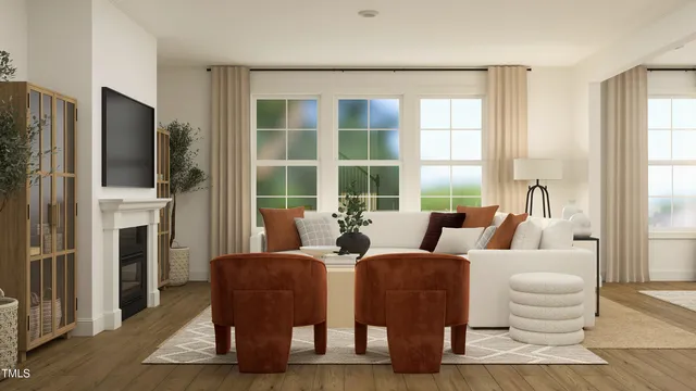 a living room with furniture fireplace and a large window