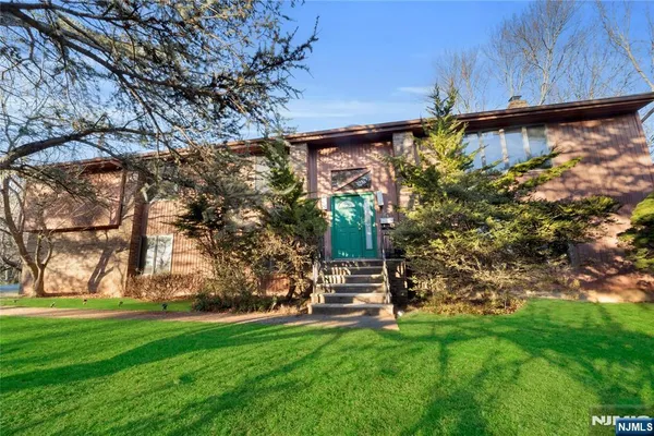 a view of a field of grass and trees