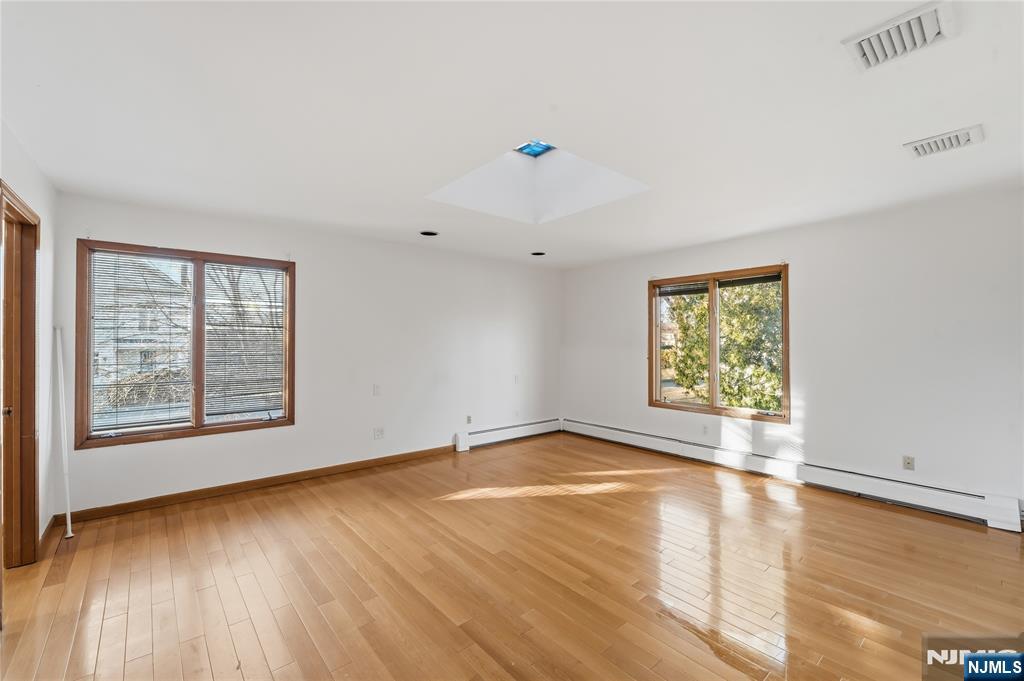 325 High Street Closter, NJ 07624 - Photo 11 of 34 an empty room with wooden floor and windows