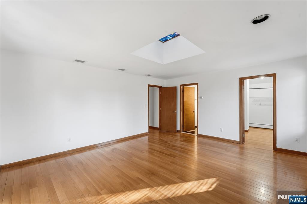 325 High Street Closter, NJ 07624 - Photo 12 of 34 a view of an empty room with wooden floor and a window