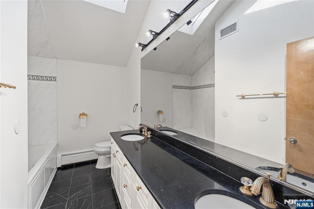 325 High Street Closter, NJ 07624 - Photo 14 of 34 a bathroom with a sink and a mirror