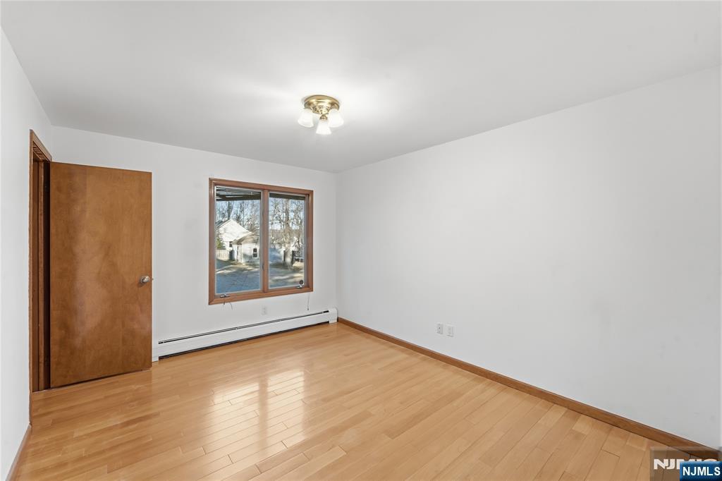 325 High Street Closter, NJ 07624 - Photo 15 of 34 an empty room with wooden floor and windows