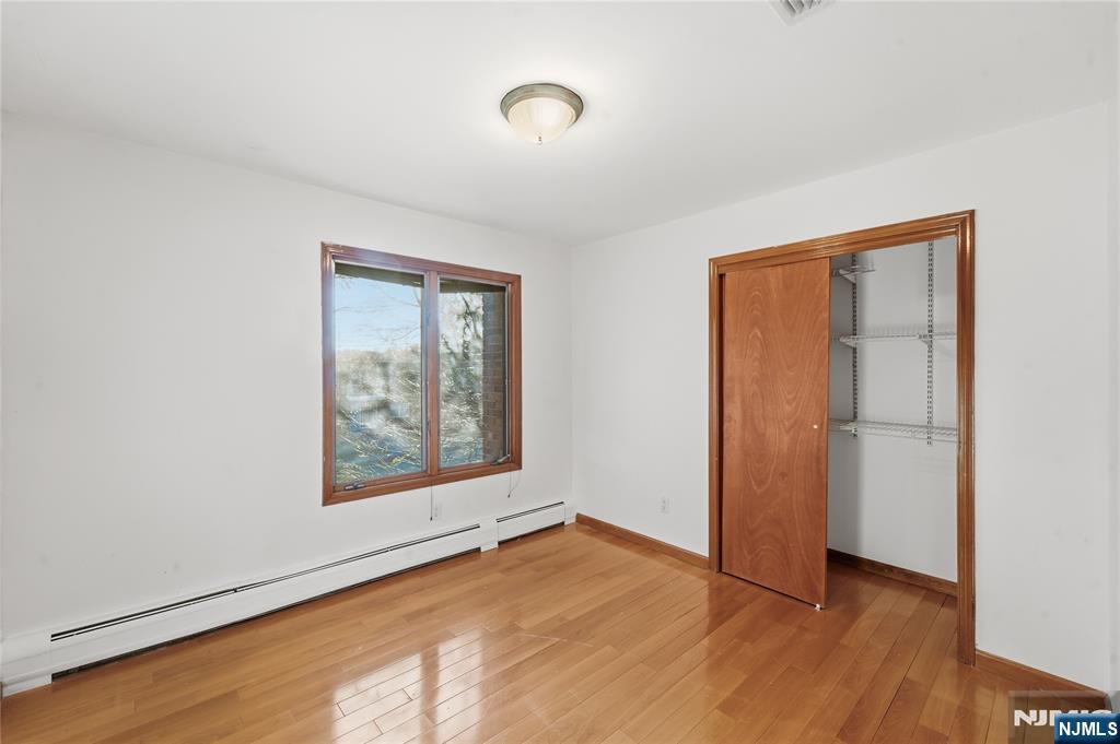325 High Street Closter, NJ 07624 - Photo 17 of 34 an empty room with wooden floor and windows
