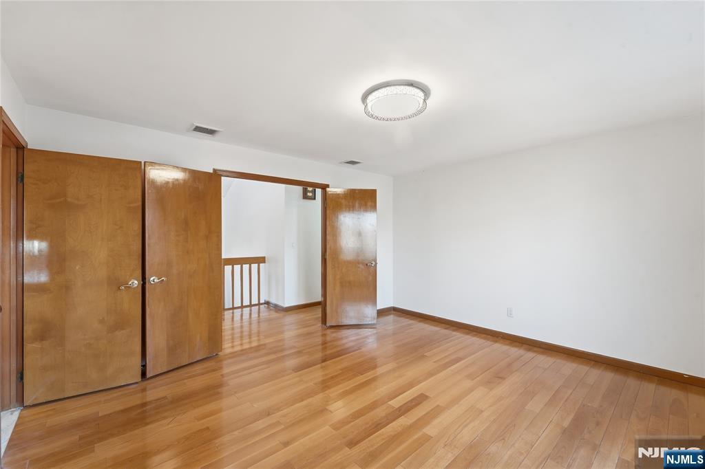 325 High Street Closter, NJ 07624 - Photo 20 of 34 a view of an empty room with wooden floor and a window