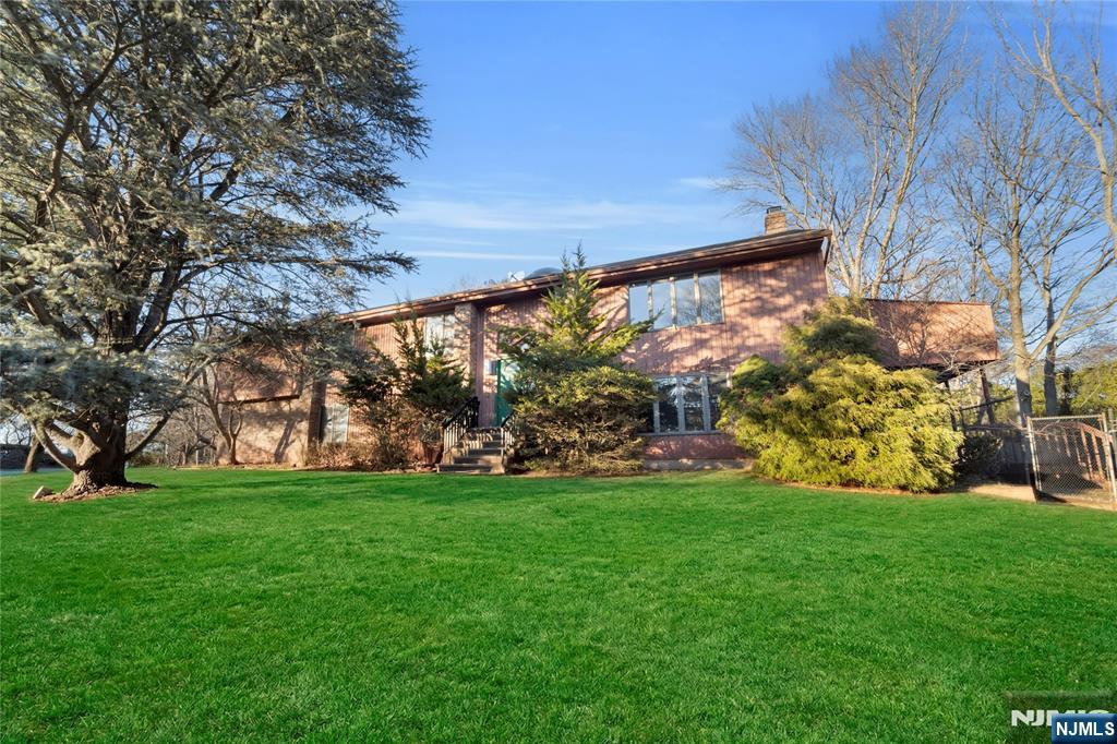 325 High Street Closter, NJ 07624 - Photo 2 of 34 a view of a field of grass and trees