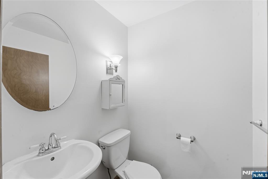 325 High Street Closter, NJ 07624 - Photo 22 of 34 a bathroom with a sink mirror and toilet