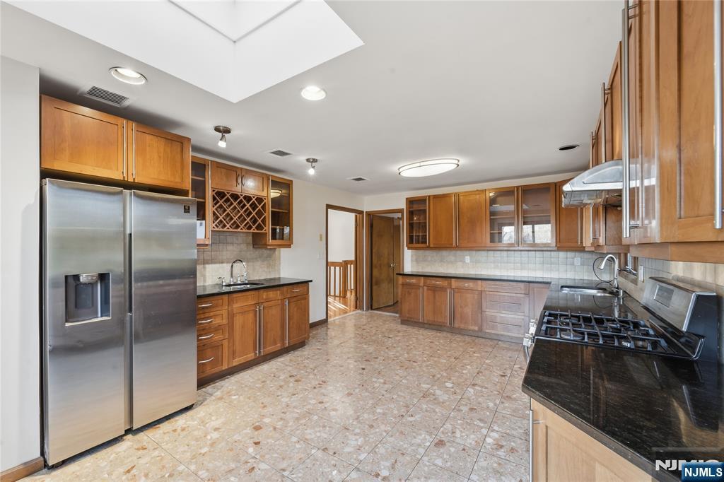 325 High Street Closter, NJ 07624 - Photo 5 of 34 a kitchen with stainless steel appliances granite countertop a refrigerator and a stove