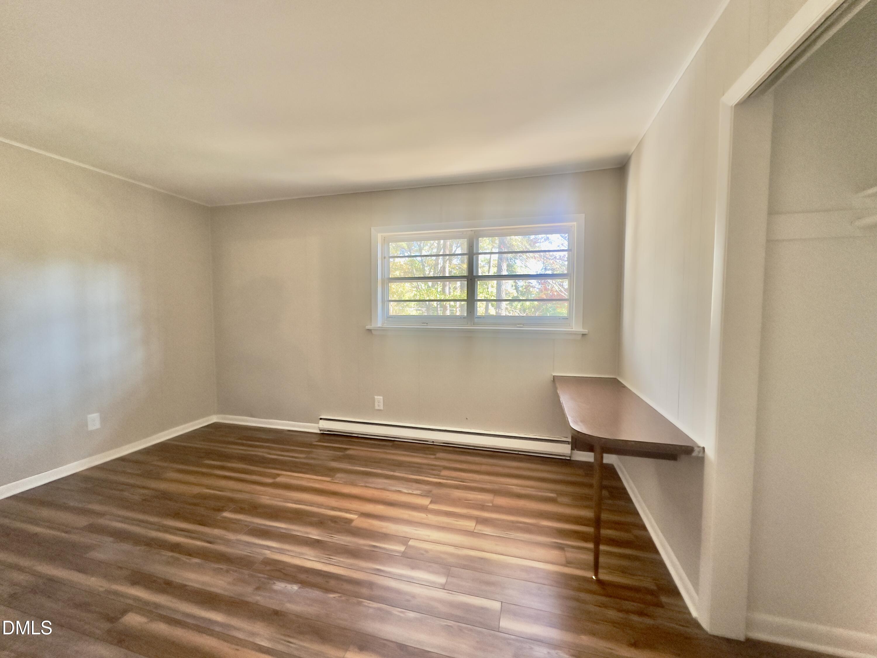 405 North Main Street Wake Forest, NC 27587 - Photo 14 of 21 wooden floor in an empty room with a window