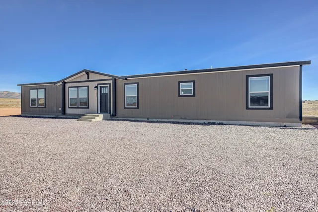 a living room with furniture and a ceiling fan