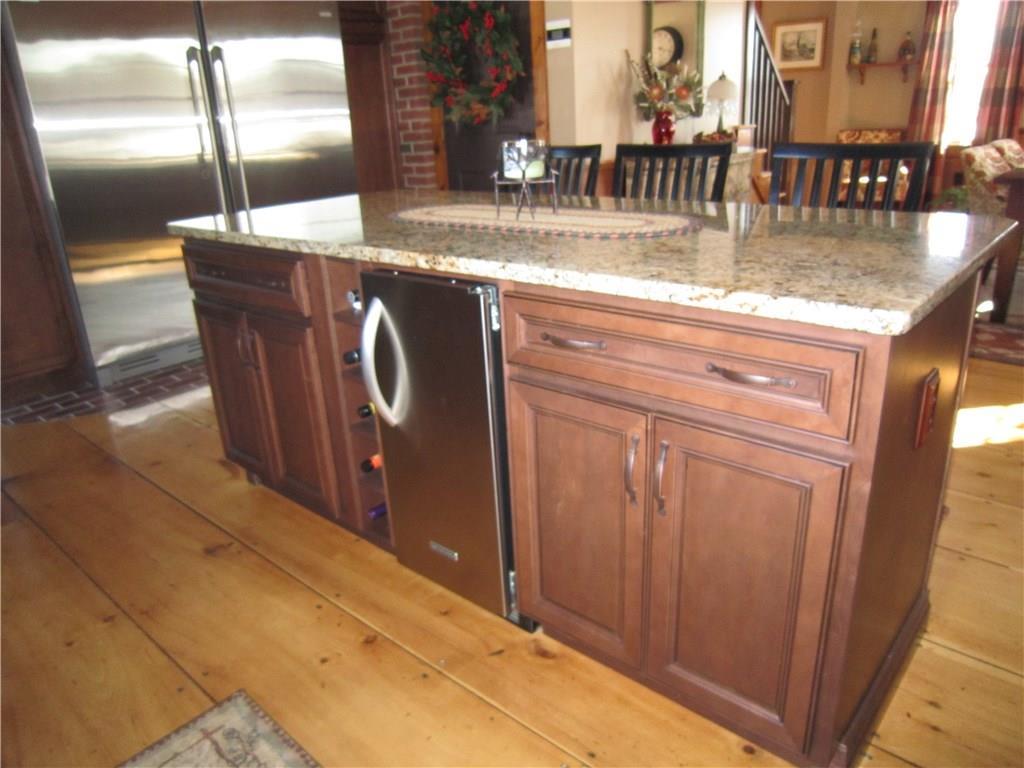 74 Hughes Road Mapleton, ME 04757 - Photo 12 of 33 Center island features a wine rack...
