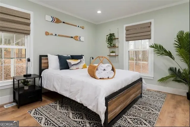 a bed sitting in a bedroom next to a window