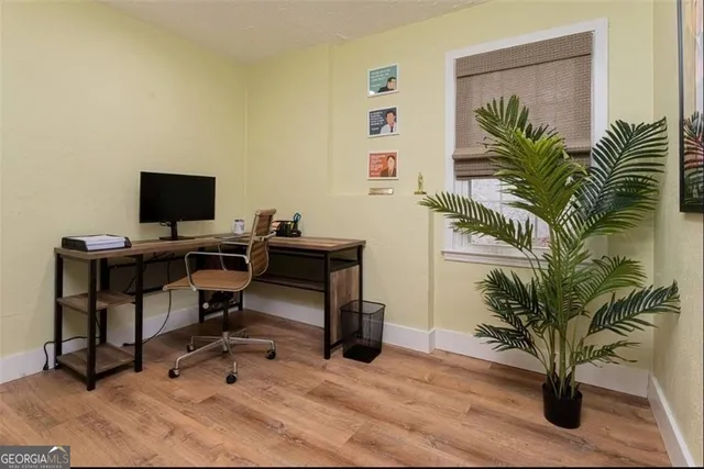 a view of a workspace with furniture and a potted plant