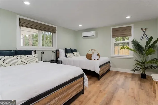 a bedroom with two beds and a potted plant