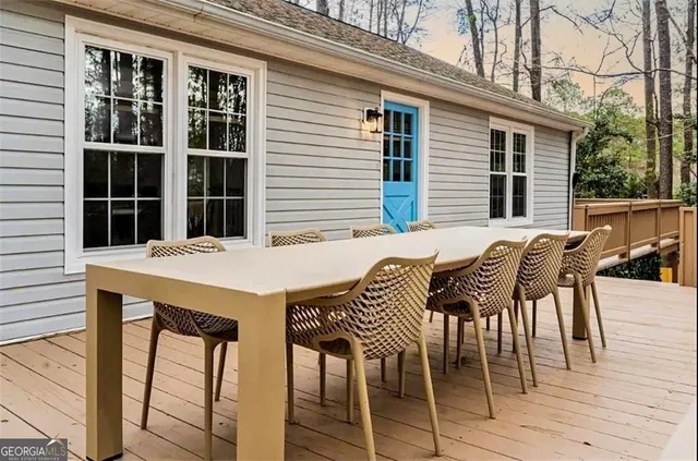 a view of a dinning table and chairs in patio of the house