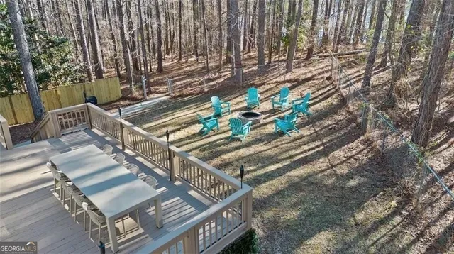 a view of outdoor space with wooden fence and trees