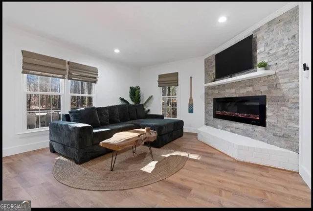 a living room with furniture a fireplace and a flat screen tv
