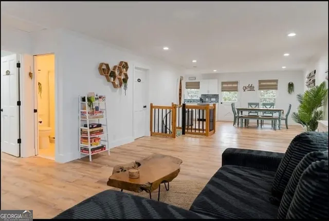 a living room with furniture and wooden floor
