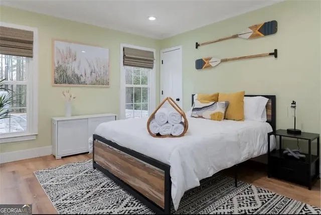 a bedroom with a bed and wooden floor