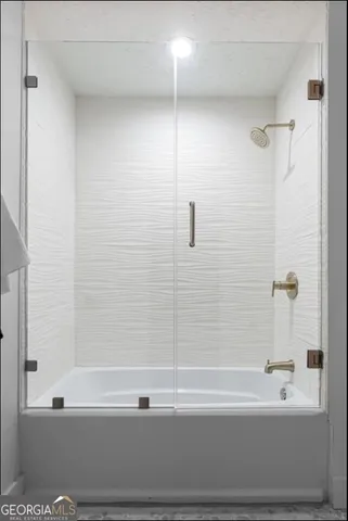 a bathroom with a bathtub and a shower