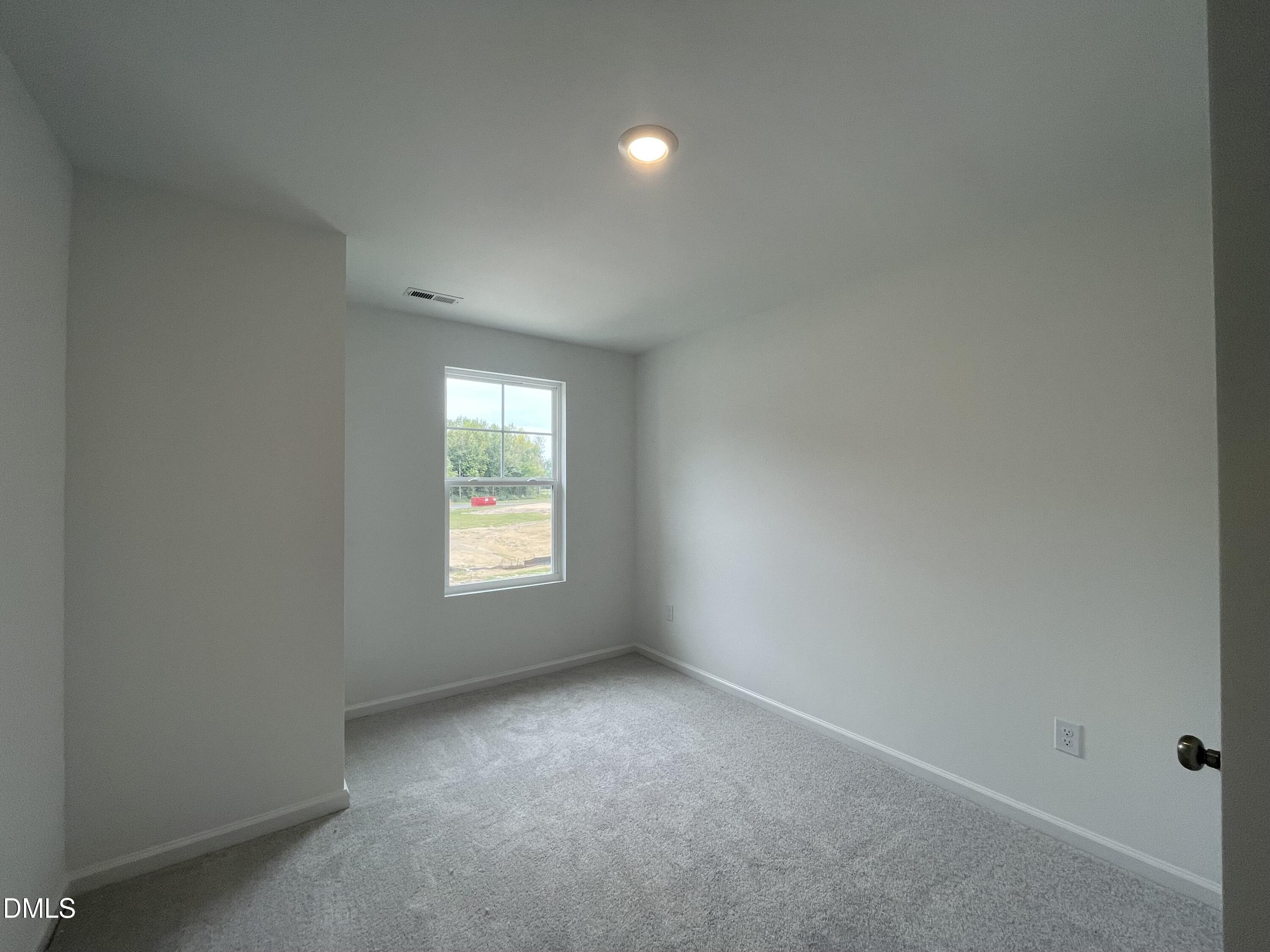 66 Digging Time Avenue Princeton, NC 27569 - Photo 12 of 47 a view of an empty room with a window