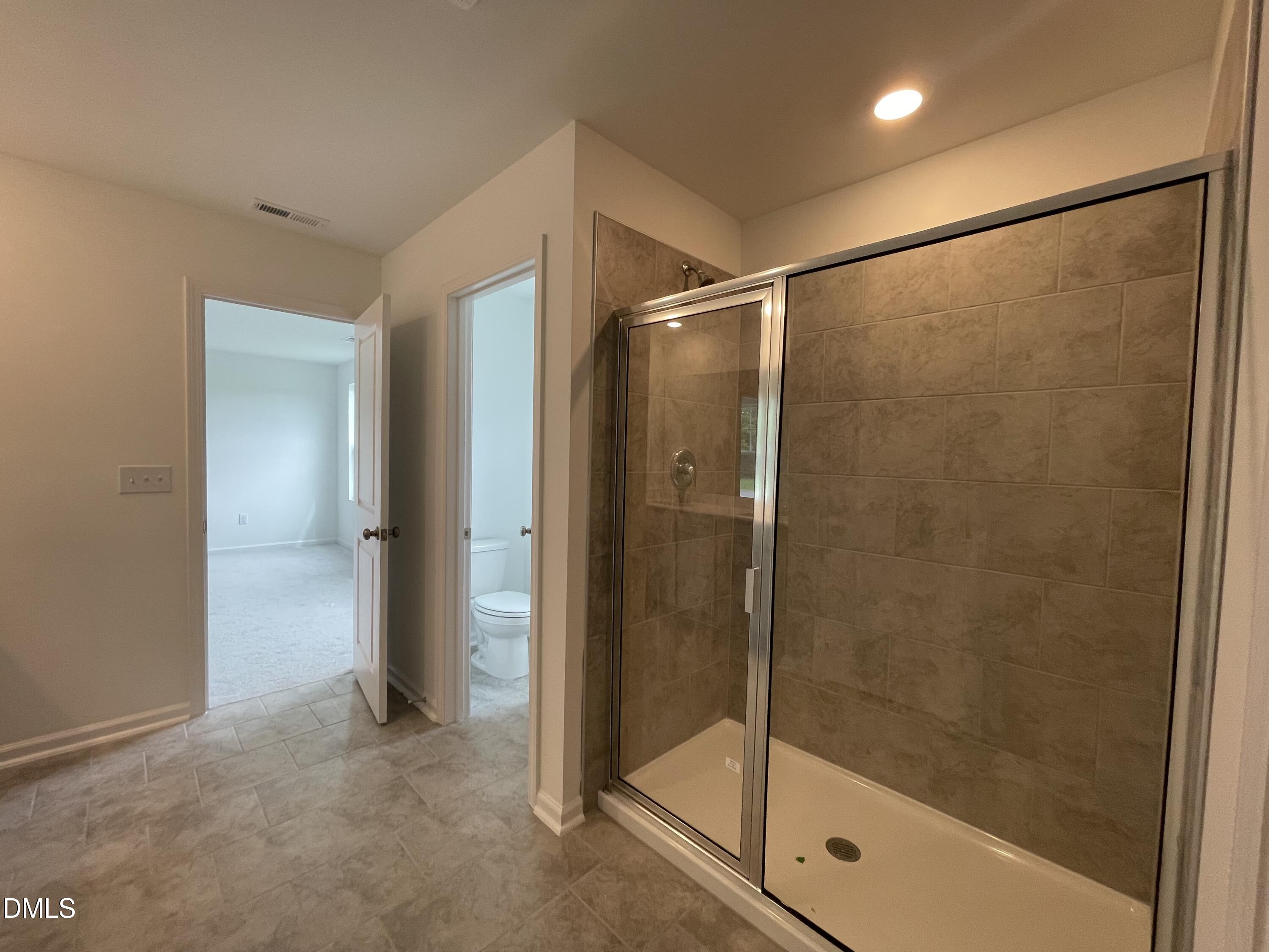 66 Digging Time Avenue Princeton, NC 27569 - Photo 18 of 47 a bathroom with a glass shower door
