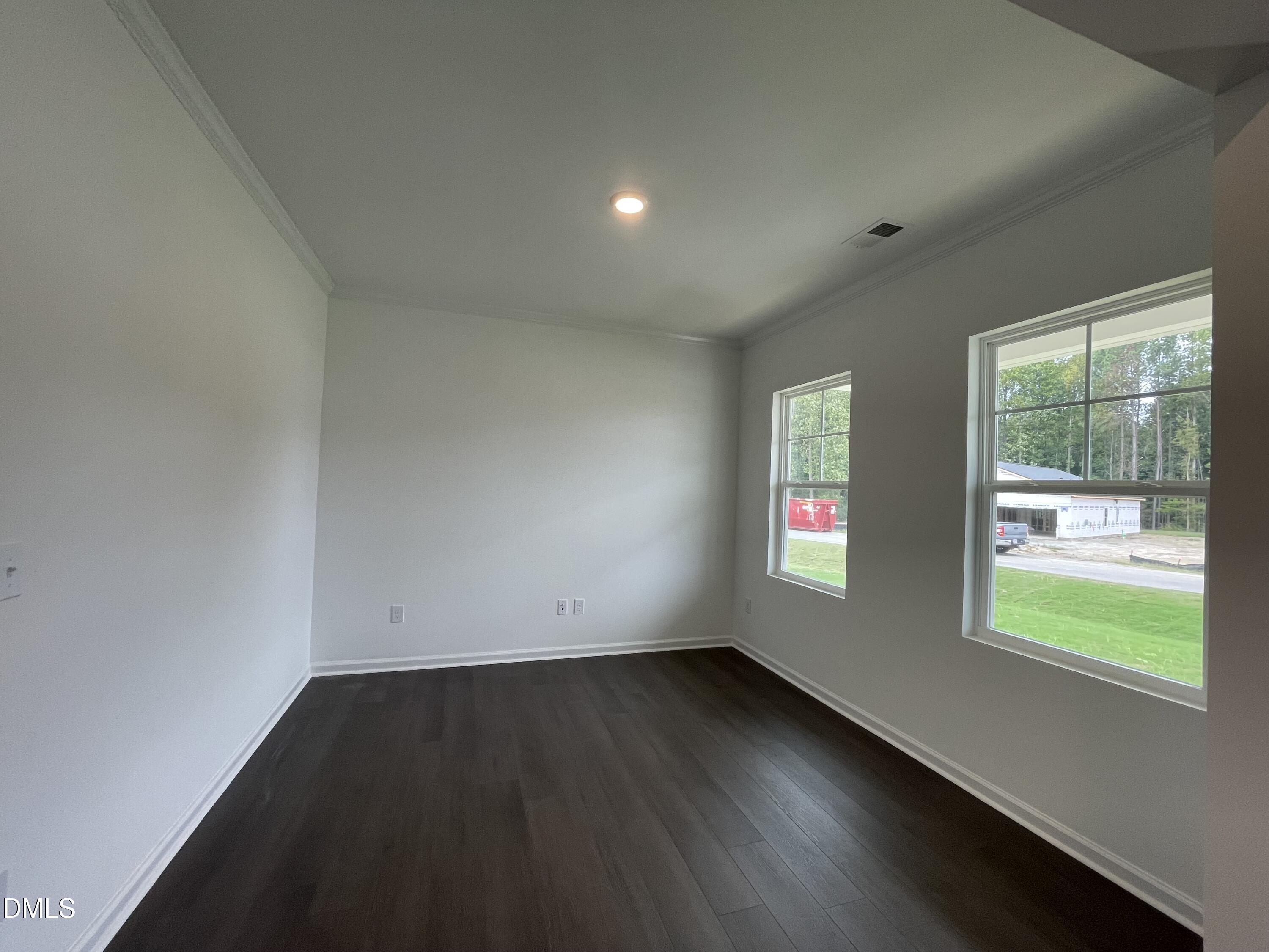66 Digging Time Avenue Princeton, NC 27569 - Photo 6 of 47 an empty room with wooden floor and windows