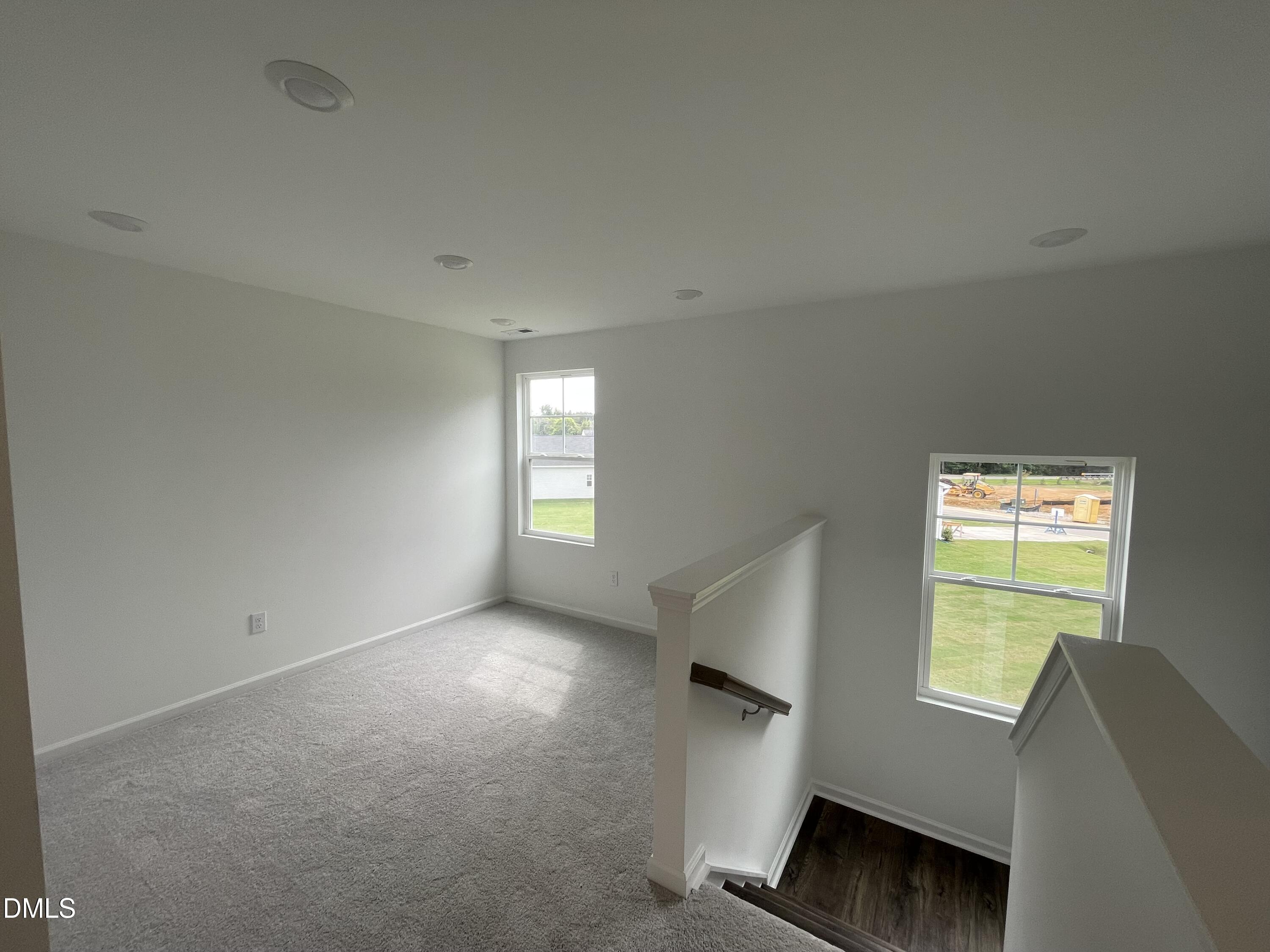66 Digging Time Avenue Princeton, NC 27569 - Photo 8 of 47 a view of an empty room with a window and wooden floor