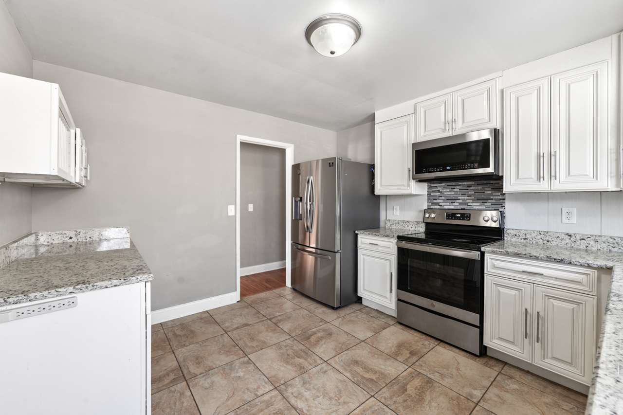 727 Lacy Avenue Streamwood, IL 60107 - Photo 11 of 30 a kitchen with a stove microwave and a sink