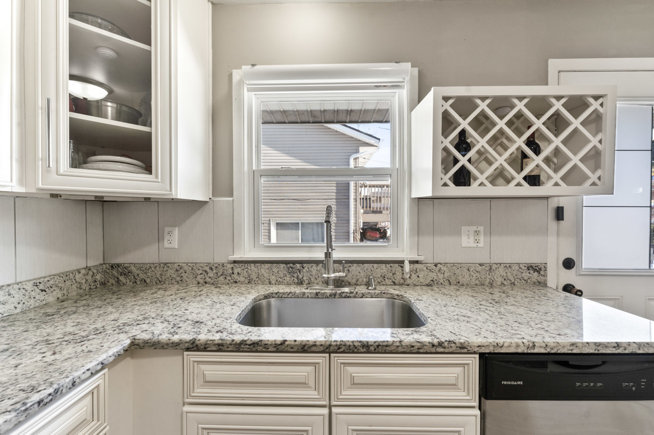 727 Lacy Avenue Streamwood, IL 60107 - Photo 12 of 30 a kitchen with granite countertop a sink and a granite counter tops