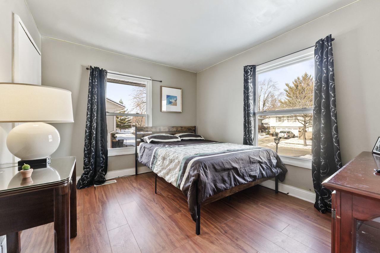 727 Lacy Avenue Streamwood, IL 60107 - Photo 16 of 30 a bedroom with a bed and wooden floor