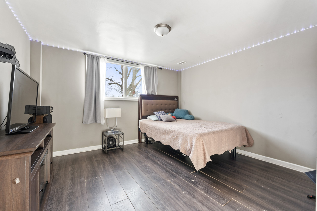 727 Lacy Avenue Streamwood, IL 60107 - Photo 22 of 30 a bedroom with a bed and a flat tv screen on the dresser