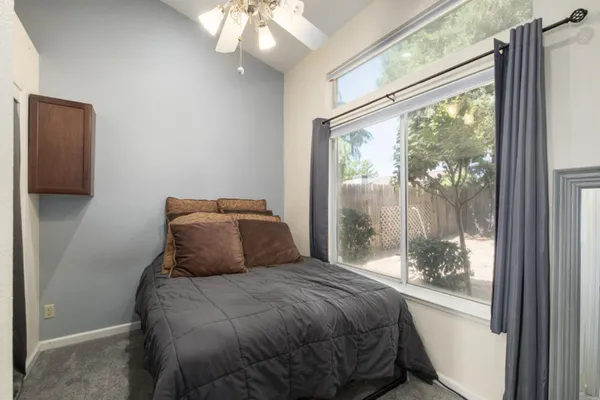 a bedroom with a large bed and a large window