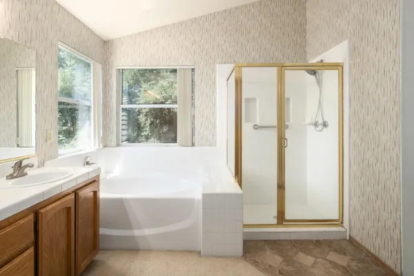 a bathroom with a bathtub and a sink