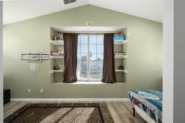 a bedroom with a bed and a window