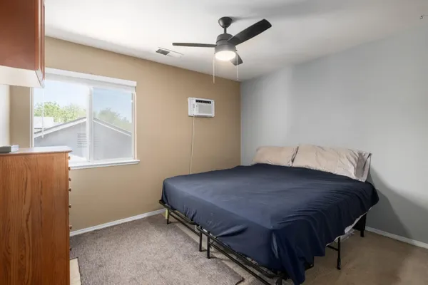 a bedroom with a bed and a window